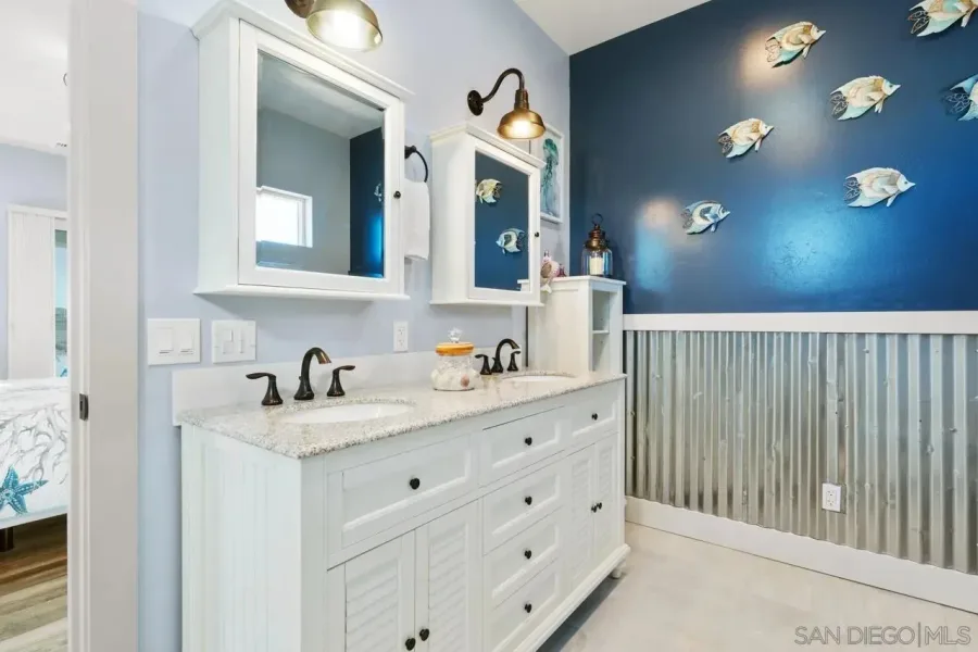 Modern bathroom renovation with marble tile and frameless shower